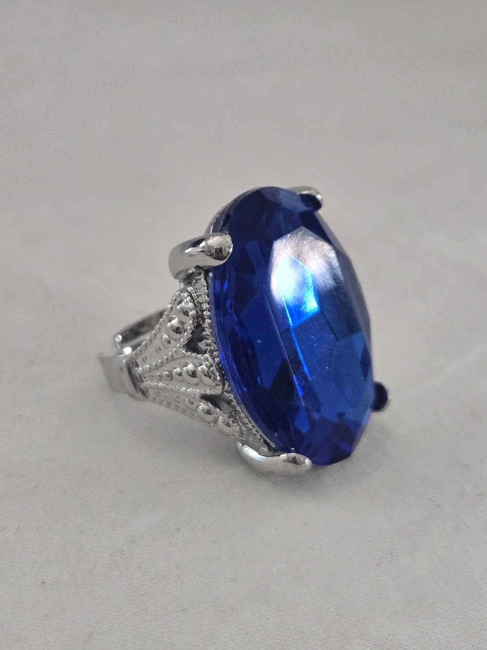Silvertone Filigree Adjustable Ring with Large Royal Blue Stone